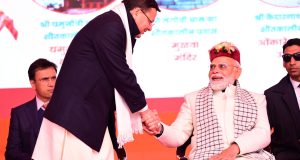 PM Modi is holding CM Dhami hand as if he doesn't want to leave his hand