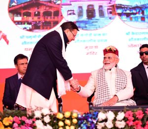 PM Modi is holding CM Dhami hand as if he doesn't want to leave his hand