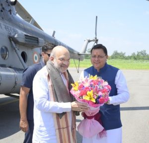 Union Home Minister Amit Shah being welcomed by CM Pushkar Singh Dhami