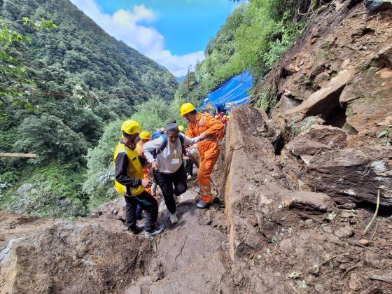 Pilgrims being guided by security personnel on Kedarnath pedestrian route